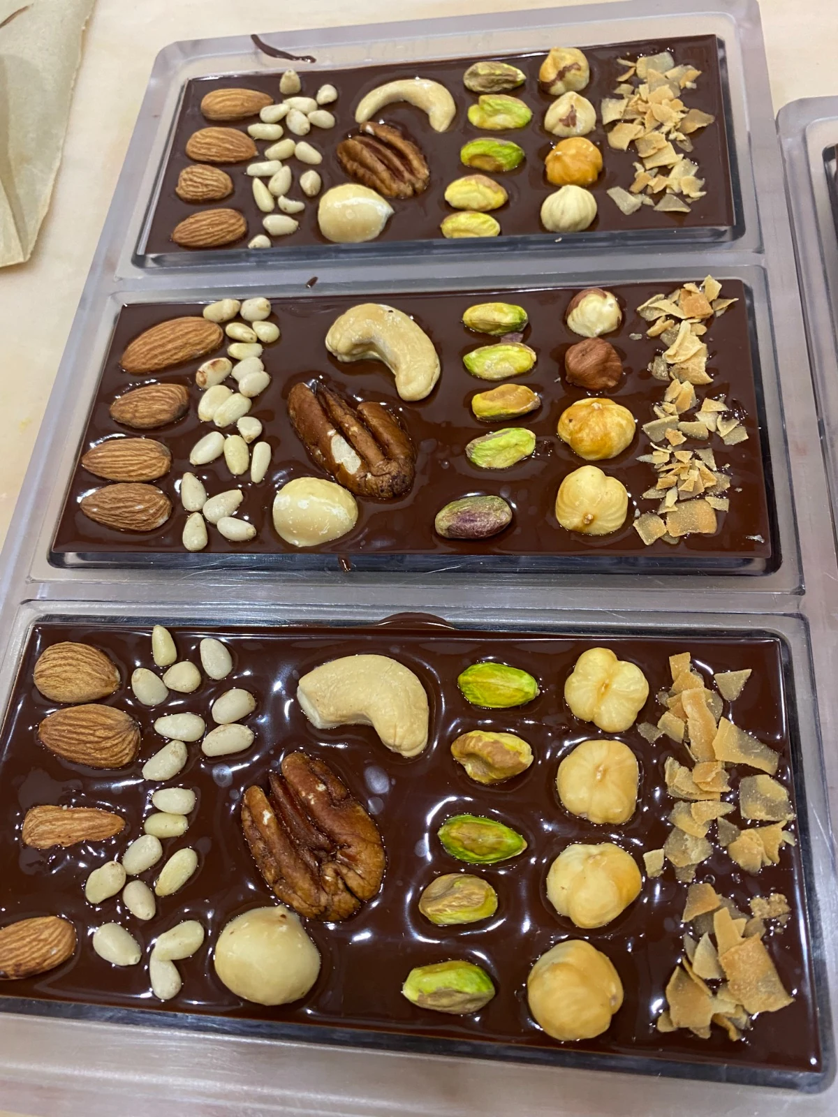 Bean-to-bar chocolate slabs decorated with nuts