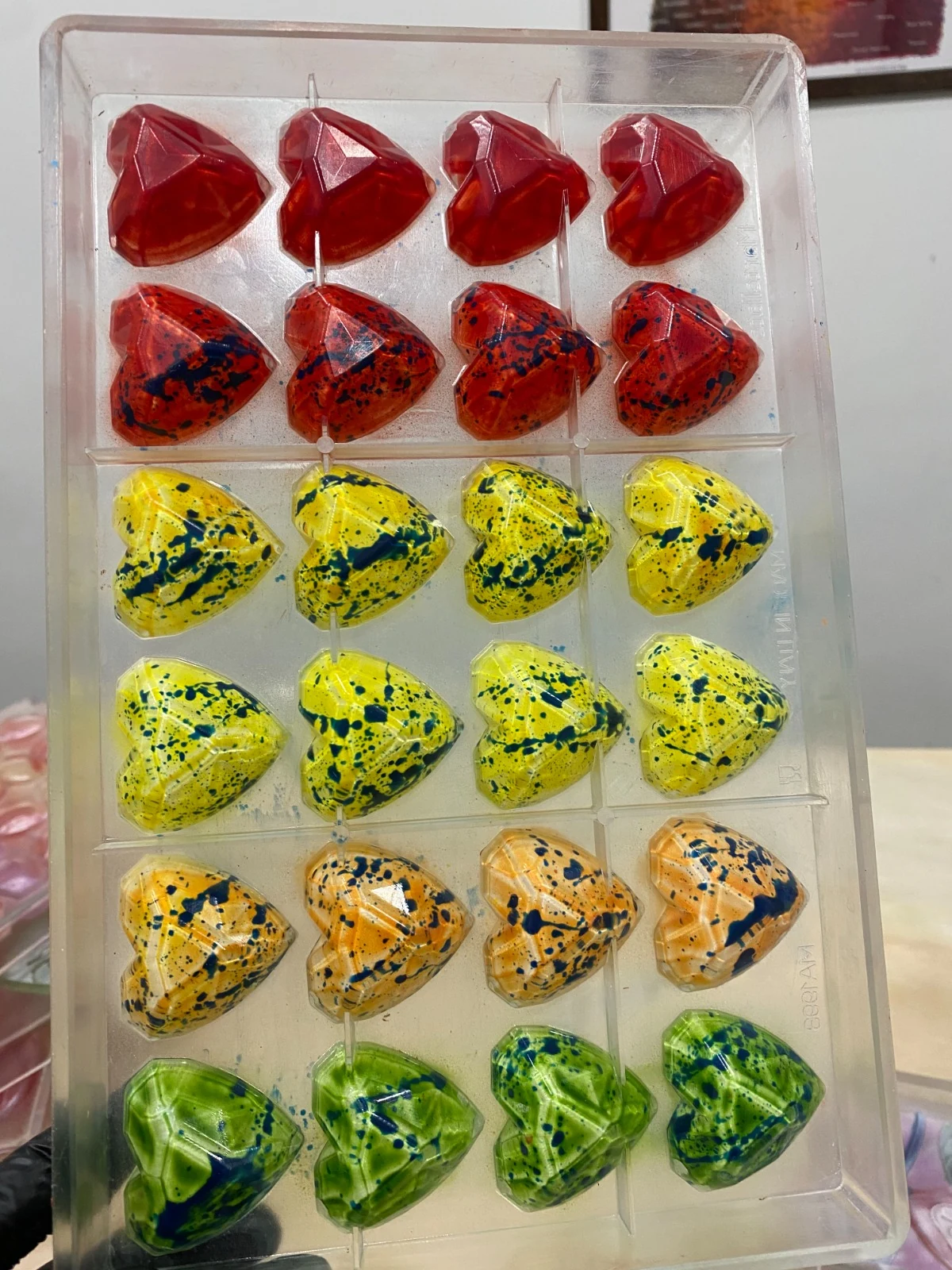 Rows of colorful hand-painted chocolate bonbons