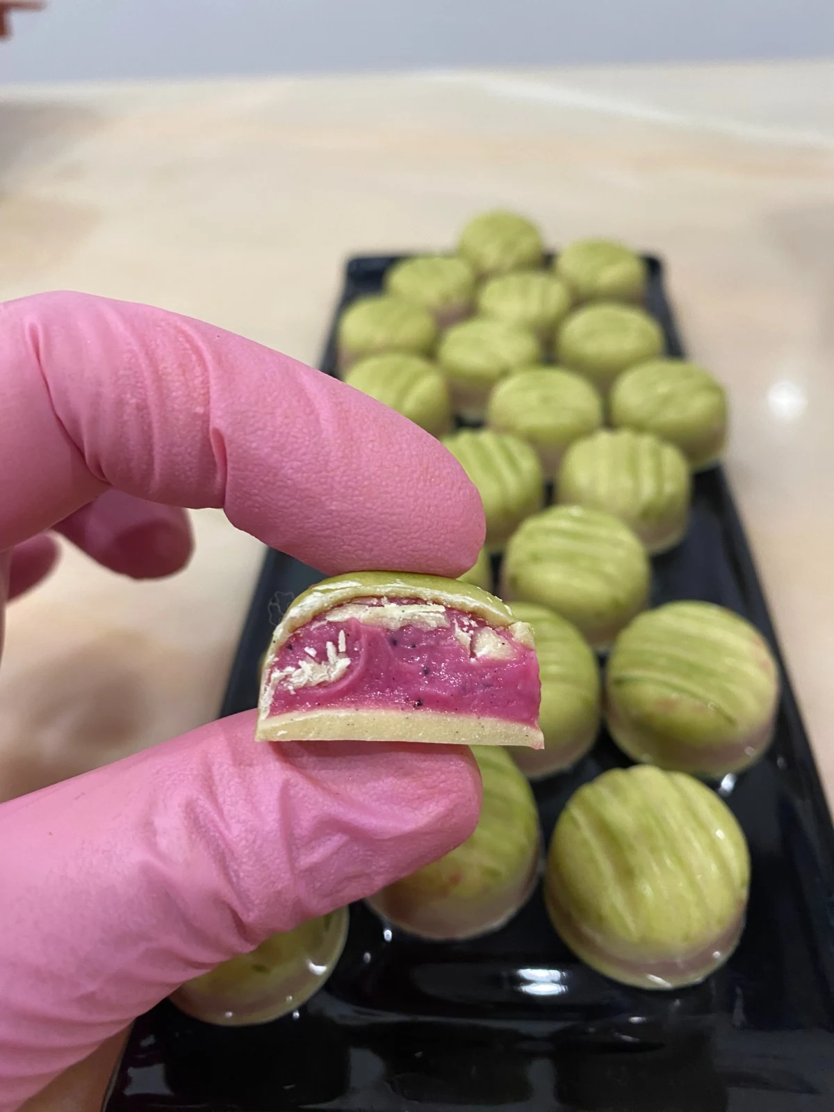 Pistachio chocolate revealing a bright fruit filling