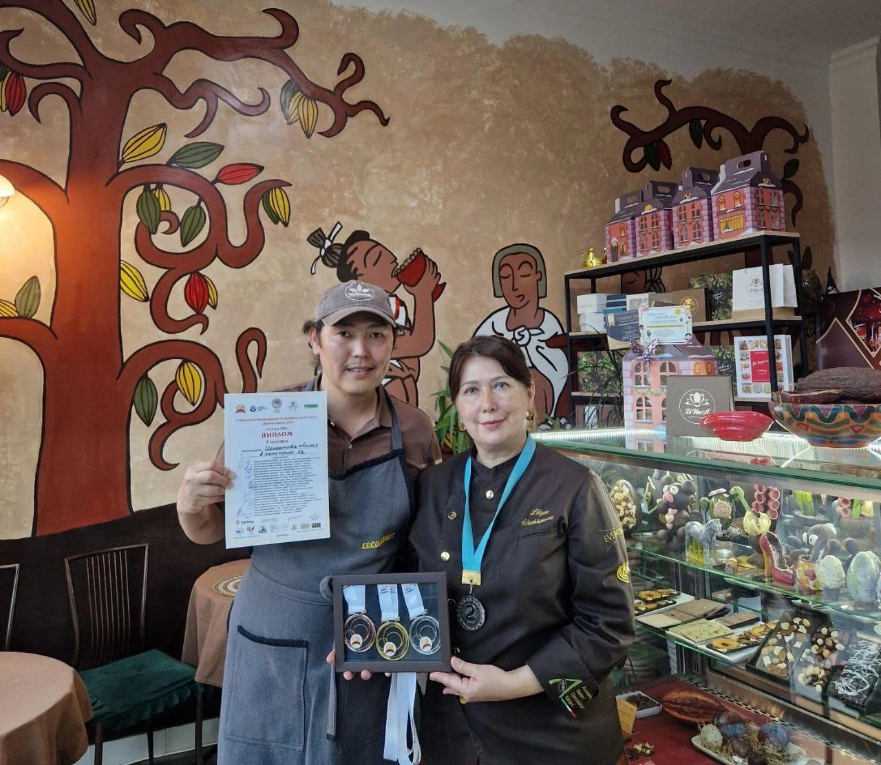Chocolate makers sharing a certificate and artisan collection