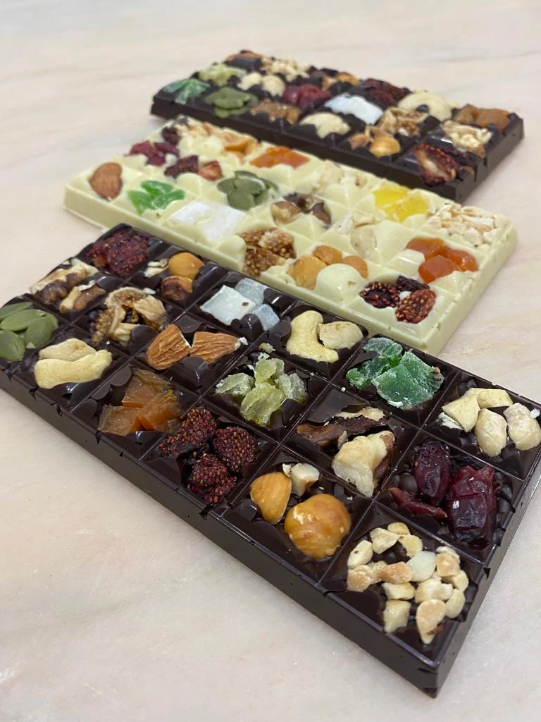 Artisan chocolate bars decorated with fruit and nuts